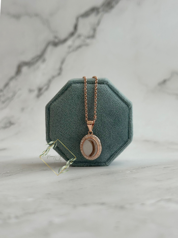 Oval bezel necklace with faux diamond stones encompassing it.